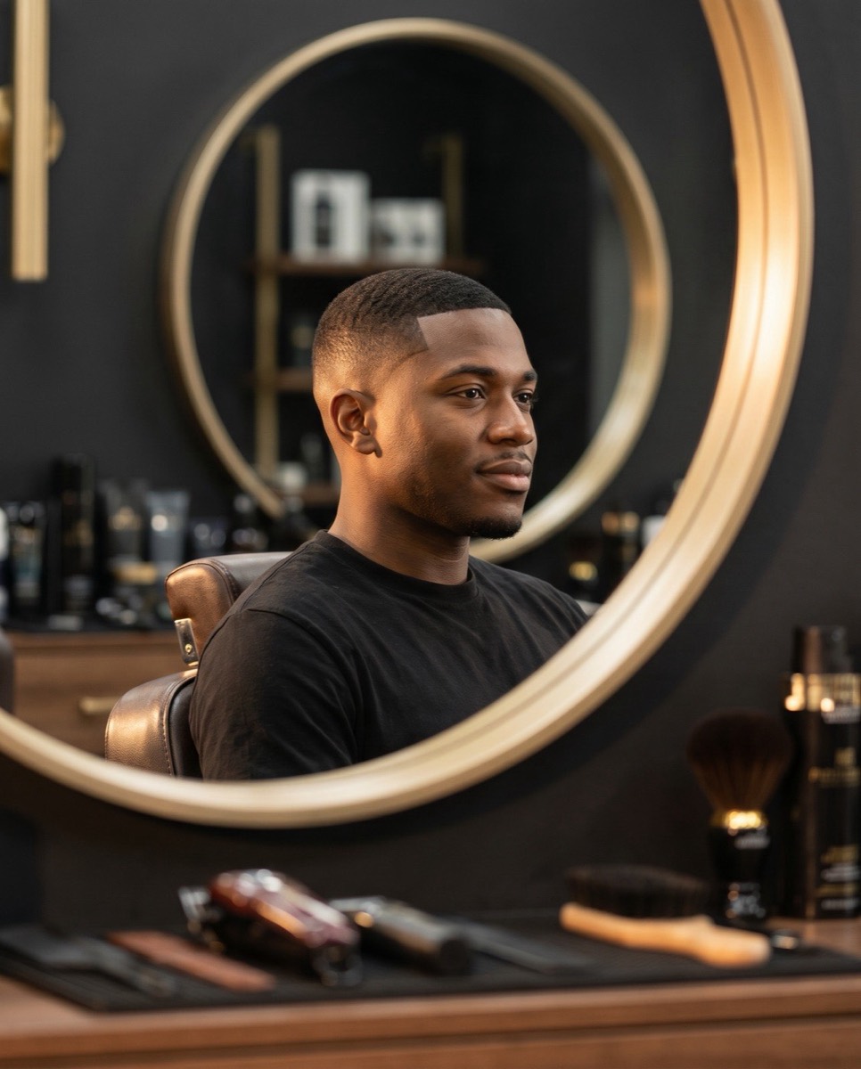 Sharp men's skin fade and precision cut on a Black client at Colaizzi's Hair Styling